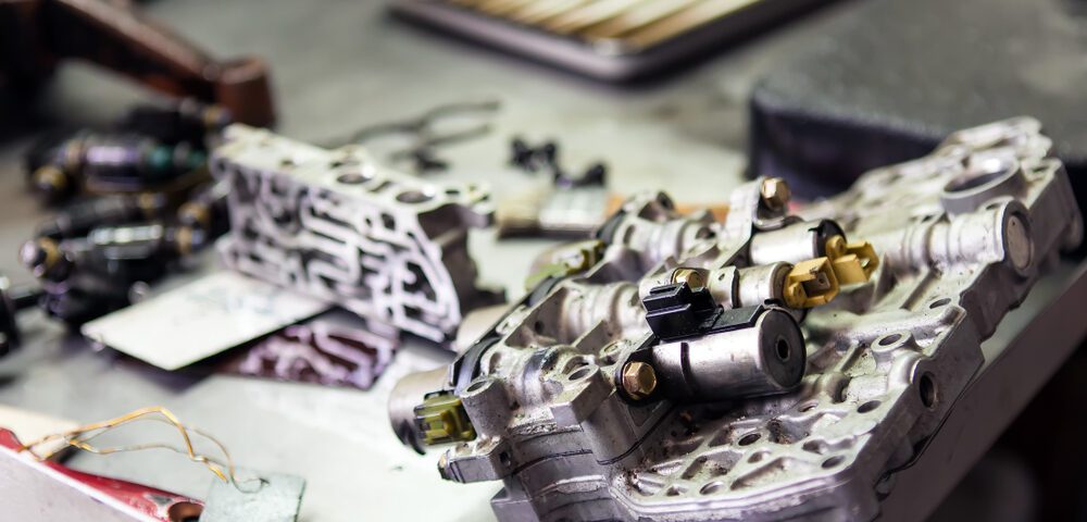 Engine parts on a metal workshop table.