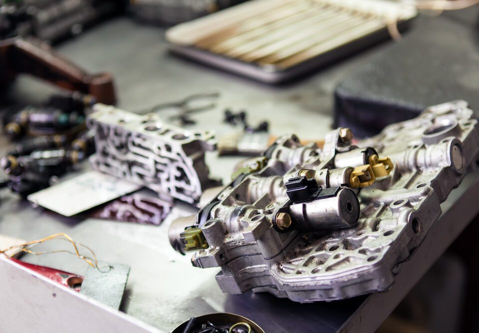 Engine parts on a metal workshop table.