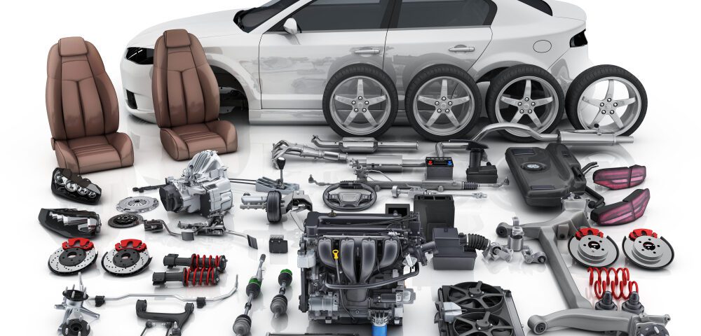 Car with various disassembled auto parts displayed.