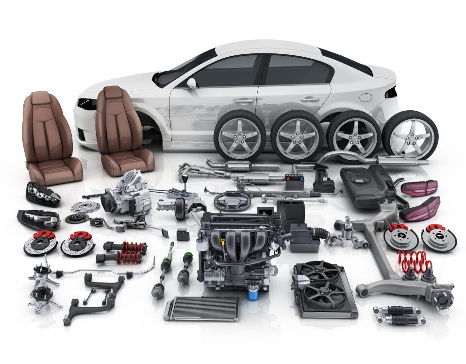 Car with various disassembled auto parts displayed.