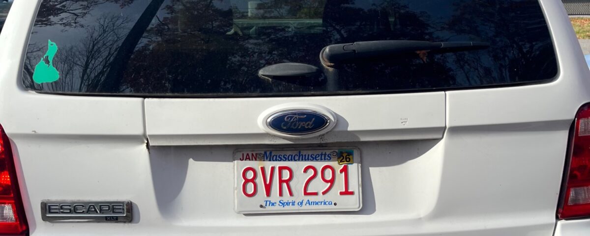 Rear view of a white SUV with a Massachusetts license plate.